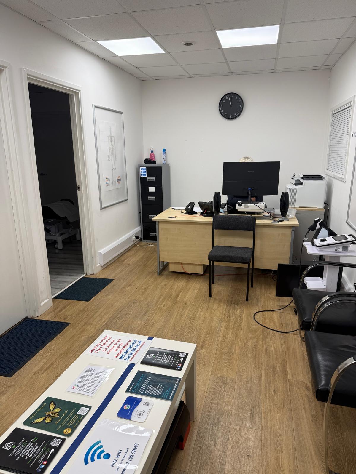Reception and waiting area at PC Physiotherapy Newport Pagnell — patient registration desk and comfortable seating for private GP and physio patients